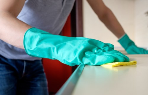 Cleaning staff following safe procedures during a carpet cleaning task